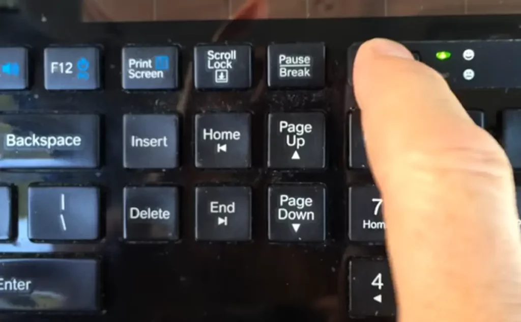  a photograph of working logitech solar keyboard with a green light